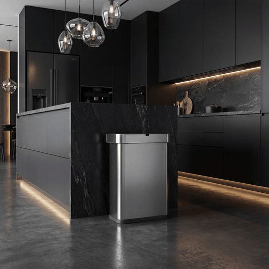 Simplehuman Recycler Can within a Modern kitchen with dark cabinets and marble island.